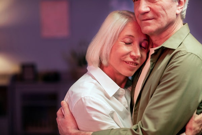 Senior couple having a party at night