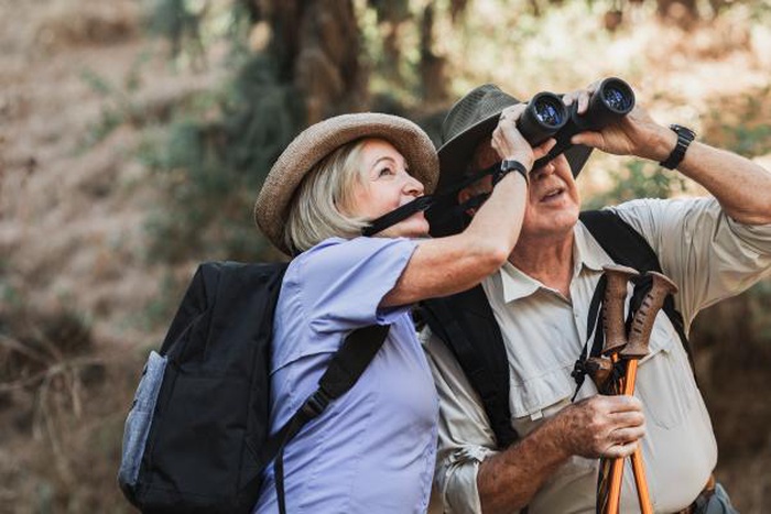 Mature senior couple hiking outdoors, active over 50 dating lifestyle