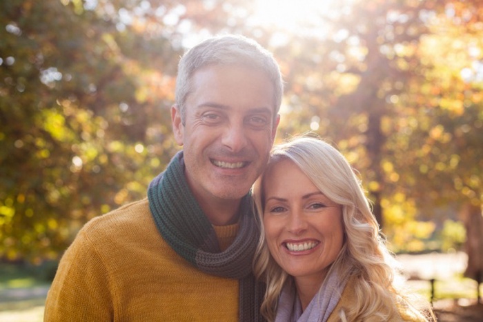 Portrait of happy couple against trees