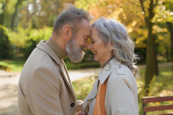 A senior couple embracing and smiling together in Lancaster, Texas, enjoying a moment of companionship and connection.