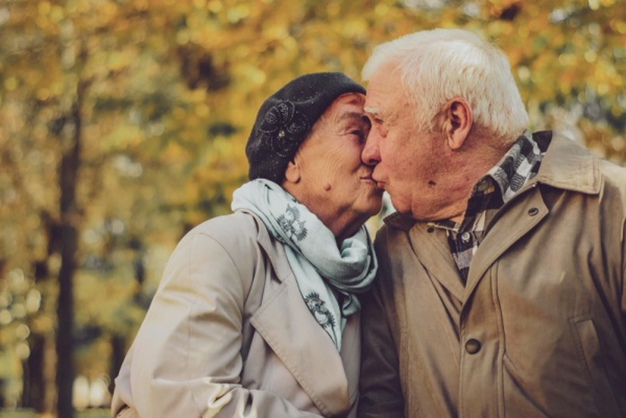Love lives forever senior couple at home handsome old man and the attractive old woman are hugging