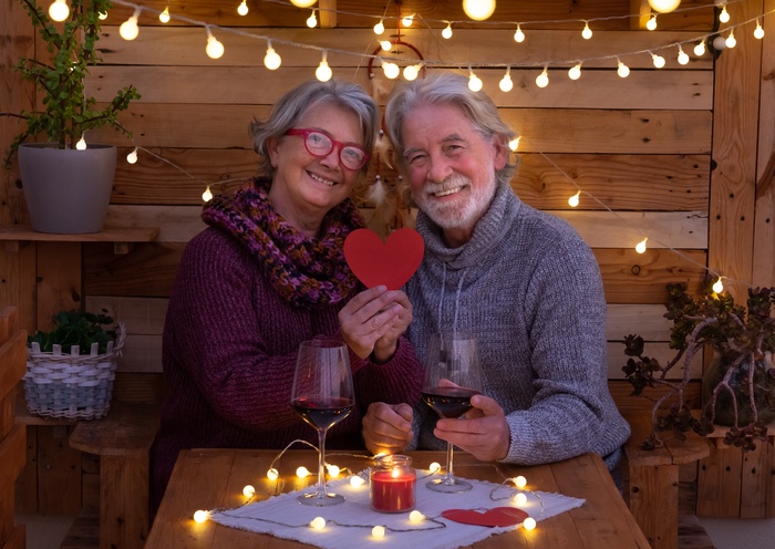 Smiling romantic senior couple at table