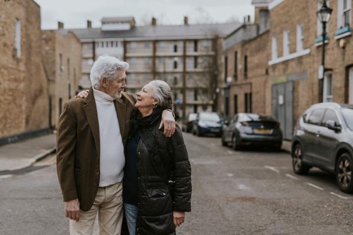 A senior couple gazing lovingly at each other in a small town