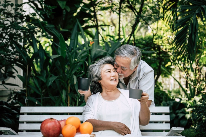 Elderly couple holding hands in park