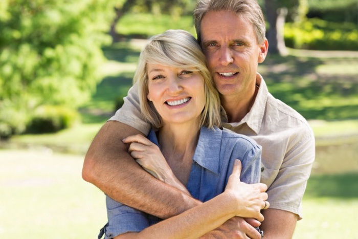 Man embracing woman from behind