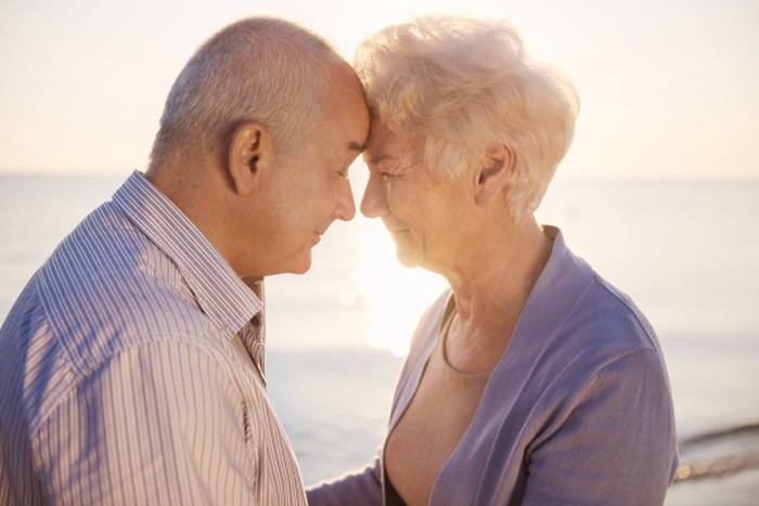 Senior couple standing face to face