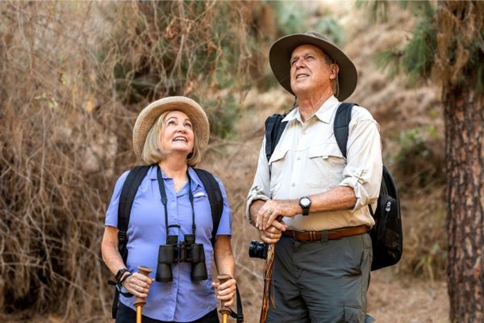 Senior nomads who met on SeniorMatch are hiking outdoors