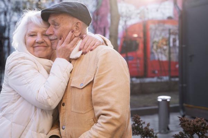 Romantic elderly couple sharing a loving outdoor hug