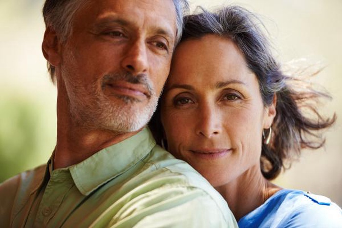Intimate close-up of a serene mature couple posing outdoors