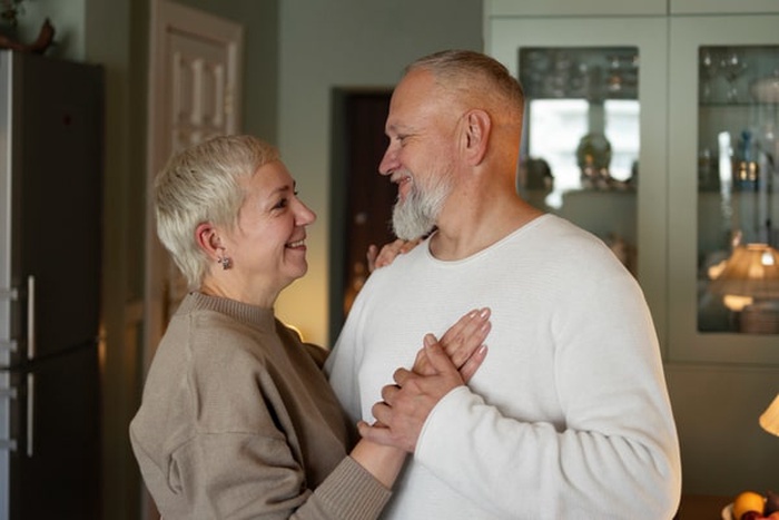 Senior couple dancing at home
