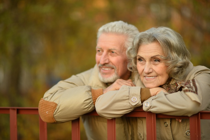  Portrait of a happy senior couple in autumn park