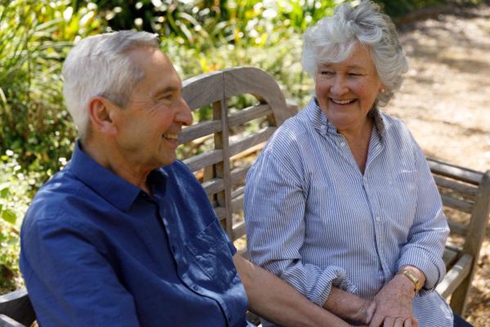 Senior couple chatting on a garden bench date