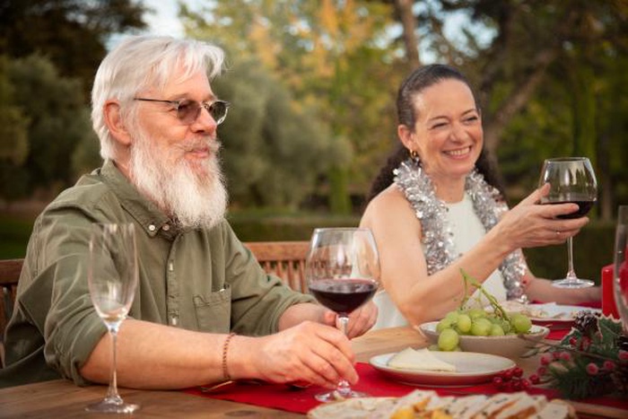Middle aged man and woman enjoy romantic dinner outdoors, senior match dating life