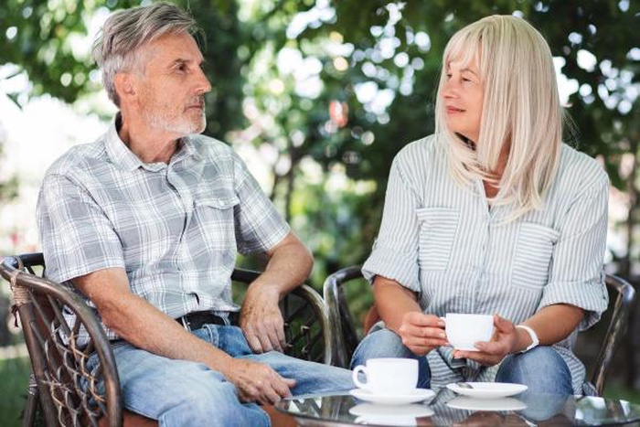 Couple drinking coffee outdoors