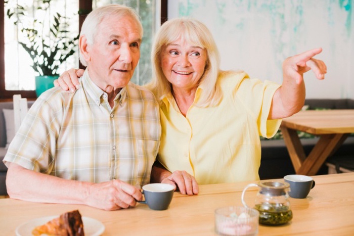  Excited elderly couple looking away