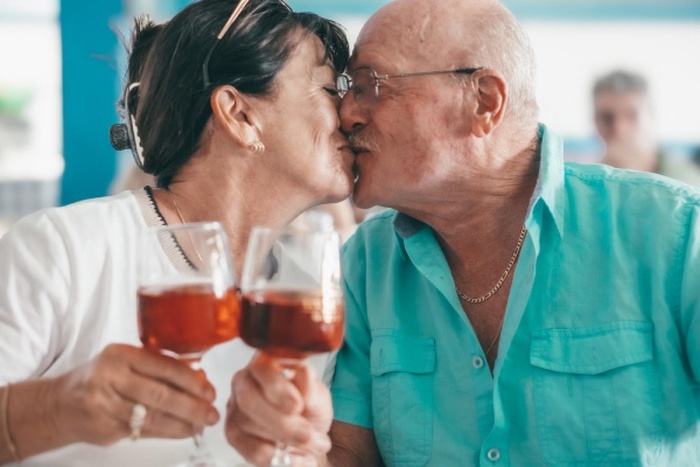 Mature couple cooking in kitchen