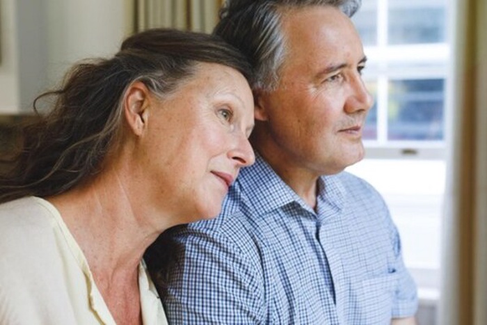 Happy senior caucasian couple sitting on sofa