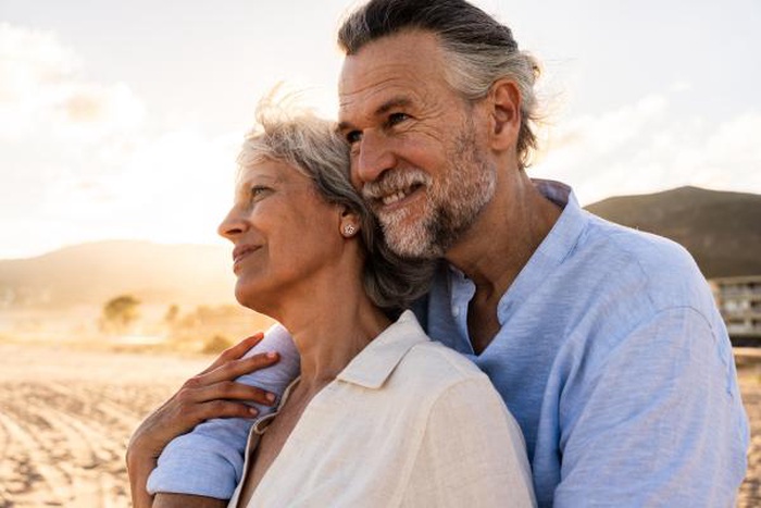 Beautiful happy senior couple dating at the seaside during summertime