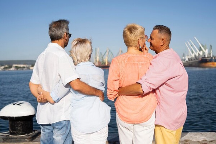 Back view senior couples traveling