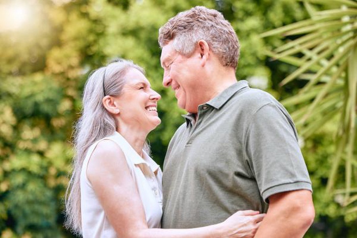 Senior couple sharing a joyful moment outdoors in natural surroundings