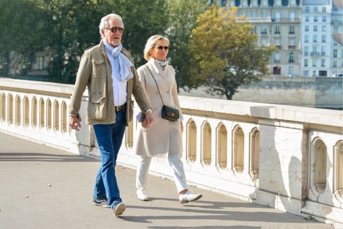 A couple who met on SeniorMatch are taking a walk outdoors.