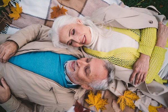 High angle view of couple relaxing on bed