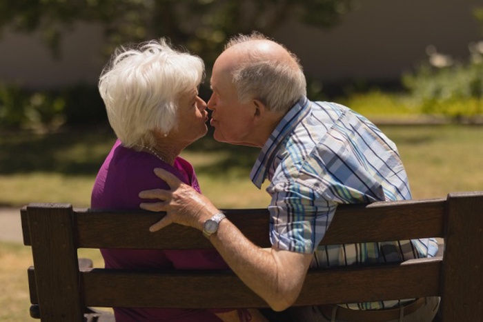 Senior couple kissing each other in the park