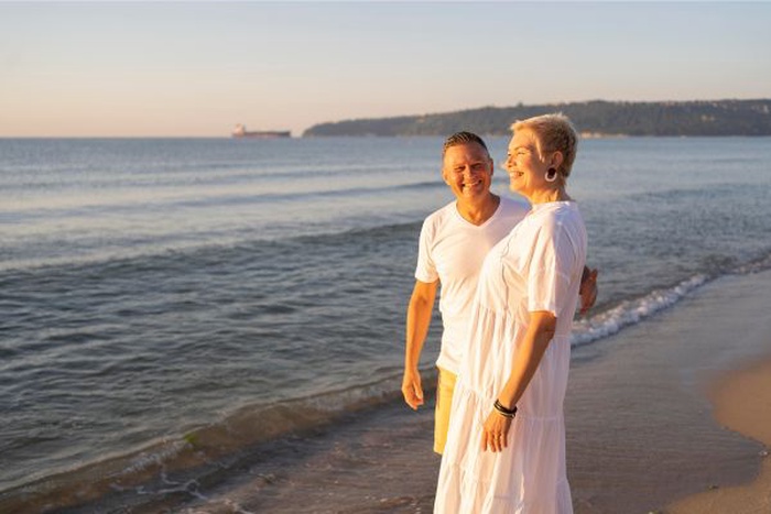 Senior couple spending time together on the beach in Royal Palm Beach, enjoying each other's company.