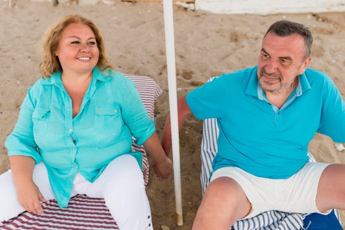 High angle of elder tourist couple at the beach