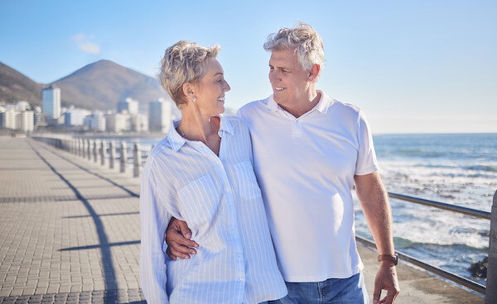 happy and mature couple in beach hug