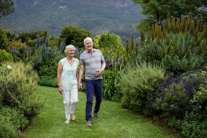 Mature couples stroll along a country path