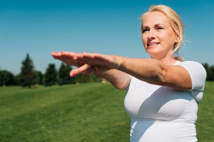 woman stretching arms out front