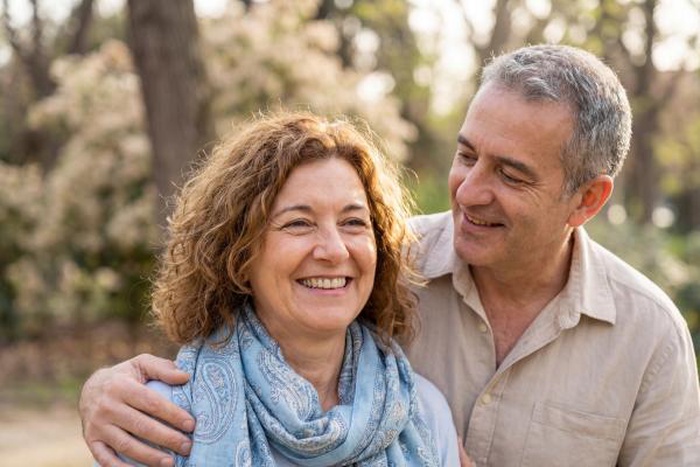 Elderly couple smiling together in a park