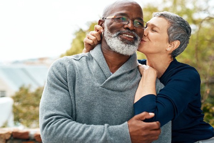 Interracial senior couple care and love in park garden