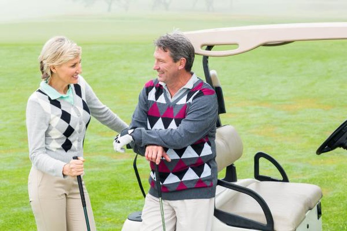 Happy aged pair enjoy golf activity together after matching on 50+ senior dating platform in USA