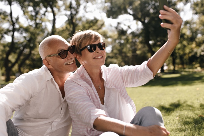 Elderly couple holding hands in park