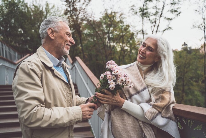 Elderly couple holding hands in park