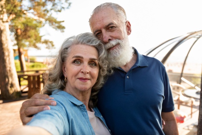 Elderly couple hugging in garden
