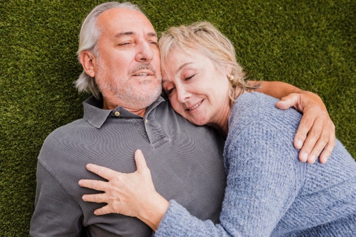 Elderly couple holding hands in park