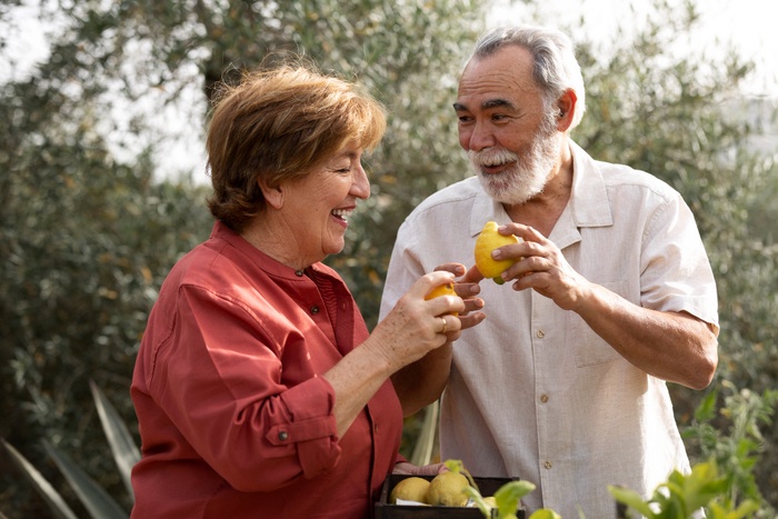 Elderly couple holding hands in park