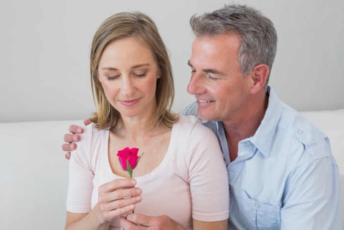 Happy romantic couple with a flower