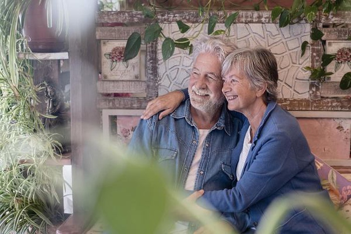 Happy elderly couple embracing talking and having fun together 