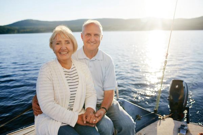 Senior couple enjoying a boat ride date on the lake