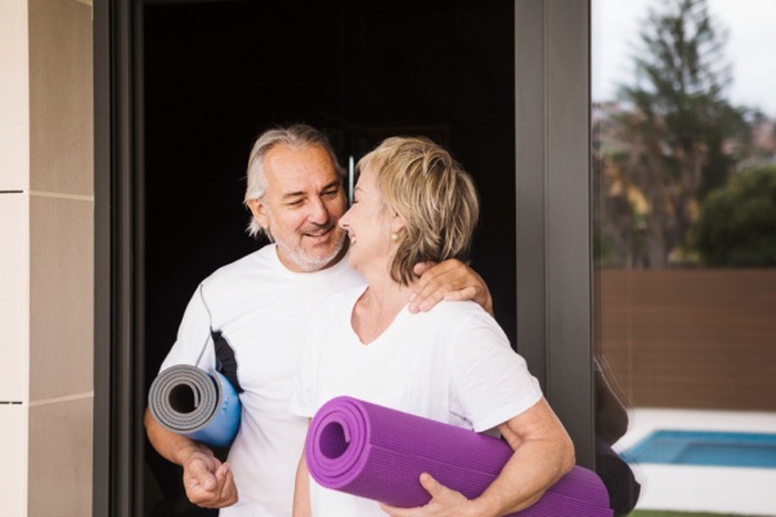 Senior couple excising in garden