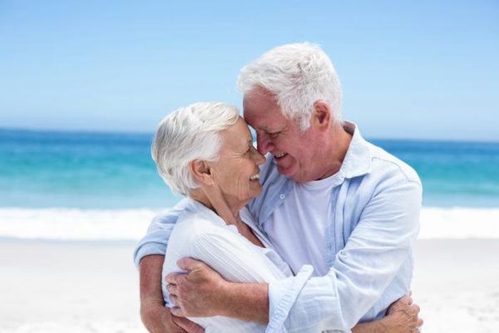 Mature couple embracing happily at North Beach, Maryland beach