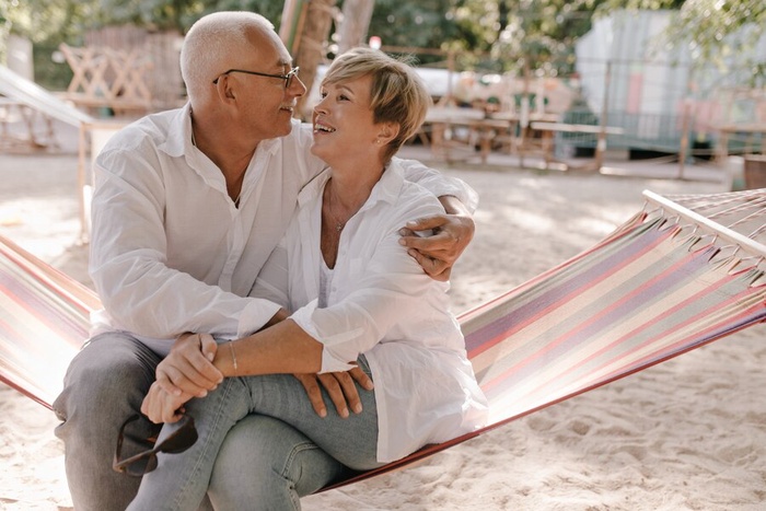 Elderly couple holding hands in park