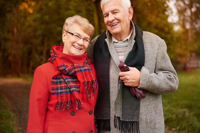 Happy smiling senior couple autumn outdoor portrait