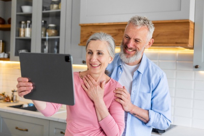  Medium shot happy senior couple with tablet