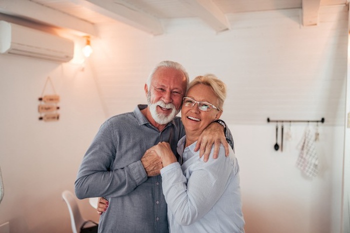 Portrait of a loving senior couple indoors.