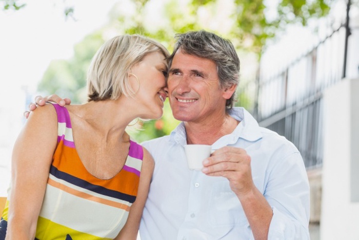  Woman whispering to man